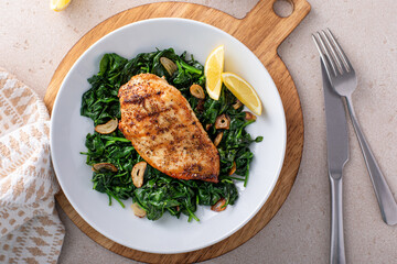 Grilled chicken with sauteed spinach, healthy dinner idea - obrazy, fototapety, plakaty