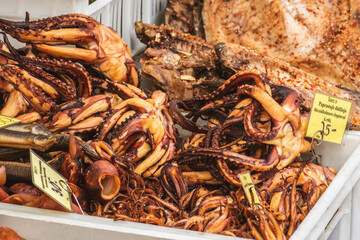 Selling smoked octopus in a street food market in Vilnius, Lithuania, Europe, close up