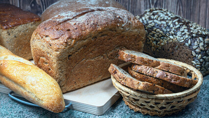 different types of wheat bread on a wooden table - 580766794