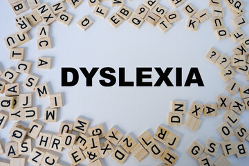 close-up wooden alphabet blocks, DYSLEXIA word on white background, dyslexia awareness, help with...