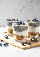 parfait blueberries with yogurt. Healthy breakfast, vegetarian vegan food on a light background.