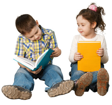 Two children sitting on the floor reading isolated on a white background