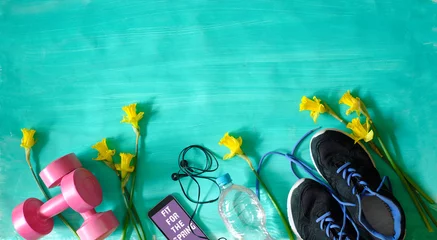 Foto op Plexiglas Getting fit,reducing weight and workout in the springtime,flat lay with fitness items and daffodil flowers © Kirsten Hinte