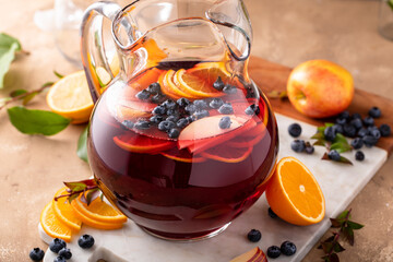 Refreshing summer berry sangria with apples, oranges and blueberry