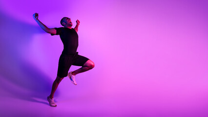 Fototapeta na wymiar Black Athlete Man Running Celebrating Victory Shouting Over Purple Background