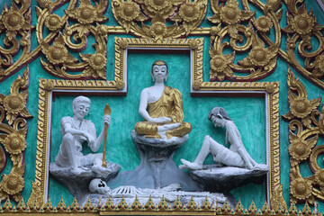 Fototapeta na wymiar Relief carvings in a Hua Hin temple. The Buddha encounters life's hardships. Thailand.
