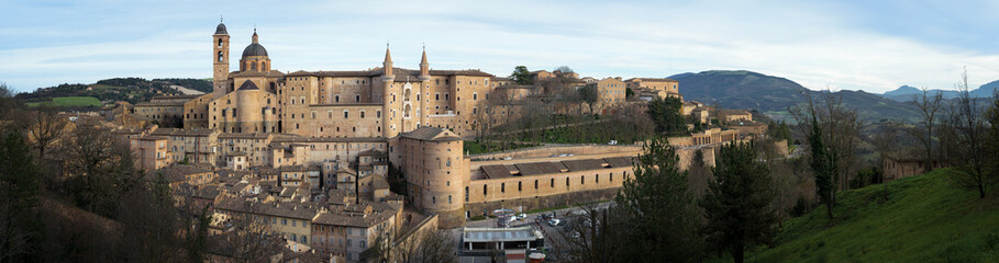 Panoramic view of the renaissance city of Urbino, Italy, birthplace of the painter Raffaello, with the ducal palace and the cathedral dome - 580771700