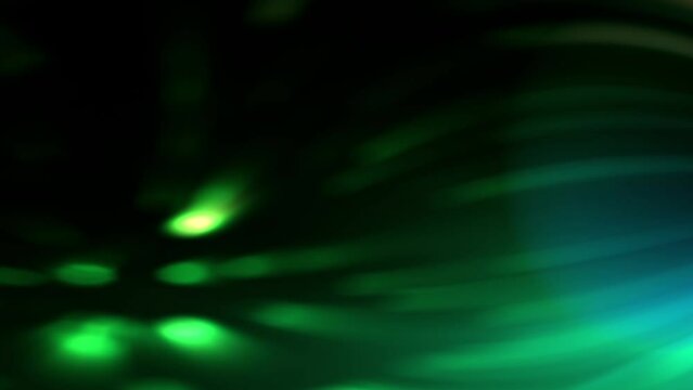 Dark backgroud, green shadow and blurry light moving on a slow motion