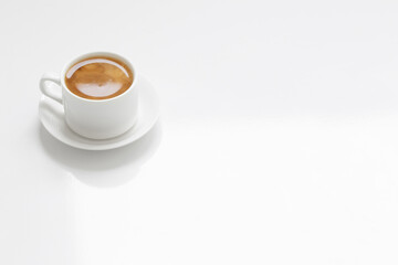white cup of coffee  on white table