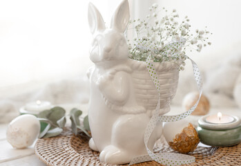 Easter composition with a ceramic hare and gypsophila flowers.