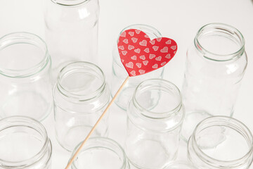 Assorted set of glass containers without lids on white background, recycling. Concept of second life to materials, various uses for glass vials.