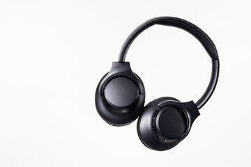 Black headband headphones to listen to music in free time, doing sports or traveling. Close-up on...