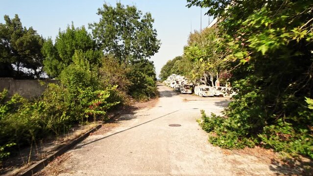 Abandoned Seaside Industrial Complex Car Chasis Bright Sunny Day FPV Fast Fly Through