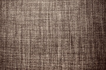 brown background fabric texture. A piece of woolen cloth is neatly laid out on the surface. Weave and textile texture. Dress fabric or for kitchen needs, tablecloth or curtains, close-up. Dash