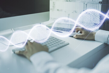 Creative light DNA illustration and hands typing on computer keyboard on background, science and...