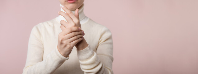 Young asian woman with white sweater cloth suffering from wrist hand pain injury. Causes of hurt include carpal tunnel syndrome, fractures, arthritis or trigger finger. world health day concept. - obrazy, fototapety, plakaty