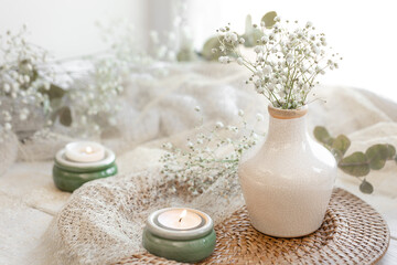 Spring composition with gypsophila flowers and candles.