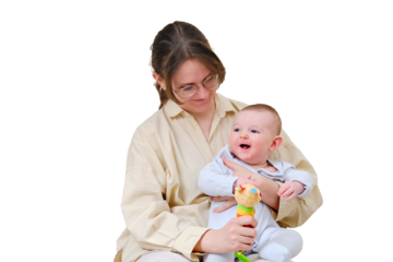 Happy woman mother playing with infant baby on home sofa in living room, isolated on a white background. Kid aged six months