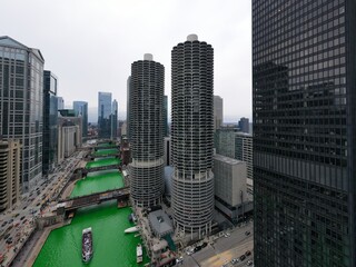 Fototapeta premium Aerial view of Chicago river dyed green for St. Patrick's day celebration. March 2023. Illinois, USA 