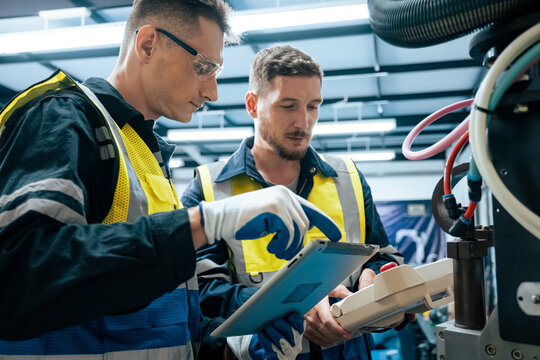 Multiracial tachnicial engineer training with robot arm