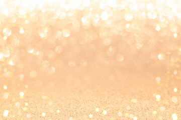 Golden sparkling background with shiny blurred round bokeh.