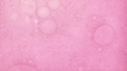 Oil and water droplets art image on pink colour.