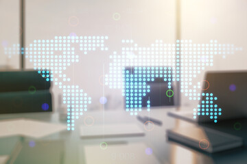 Double exposure of abstract digital world map and modern desktop with laptop on background, research and strategy concept