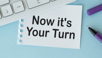 Now it's your turn text, inscription, phrase written in a notebook that lies on a dark table with a laptop and pen. Business concept. - obrazy, fototapety, plakaty