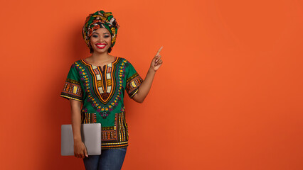Beautiful african woman freelancer posing with laptop, copy space