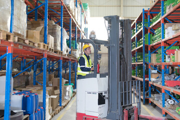 Male employee using a radio in the warehouse.