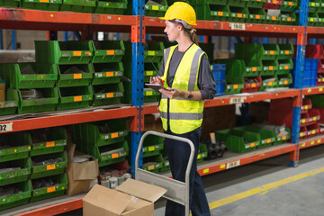 A female worker sorting goods in a warehouse.