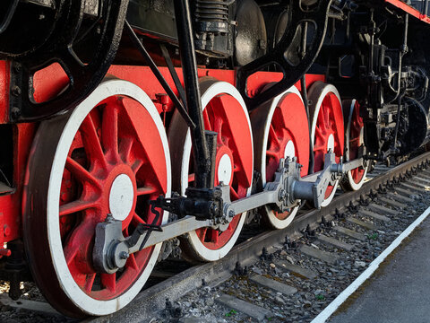 large metal wheels of an old train at a railway transport exhibition