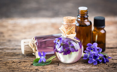 Obraz na płótnie Canvas Violet essential oil in the bottle 