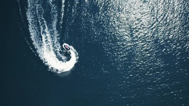 Jetski Rider Drawing a Figure Eight 8 Fast Luxury Lifestyle Island Ocean Sunny Day Top Down Drone