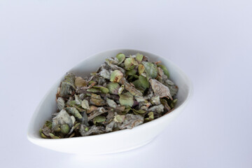 Fototapeta na wymiar Origanum dictamnus, Dittany of Crete tea in a white bowl on a white background. Cretan dittany or hop marjoram is a medicinal tea growing wild only in Crete. It is a healing, therapeutic and aromatic