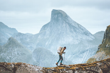 Man hiking in Norway mountains travel with backpack outdoor active vacations healthy lifestyle extreme sports exploring Lofoten islands - obrazy, fototapety, plakaty
