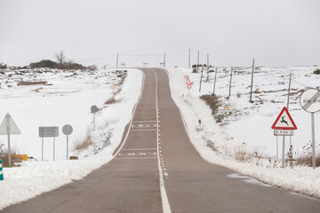 Lonely winter road, almost covered in snow