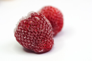  The concept of frozen food, long-term storage products. Frozen strawberries from the refrigerator.