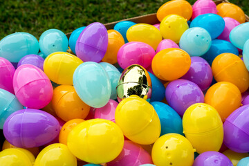 Box full of colorfull easter egg treats for children for egg hunting - special high prize golden egg
