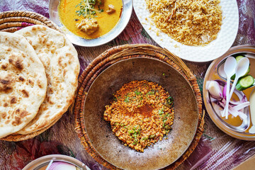 Typical Arabian dish food at simple Pakistani restaurant, lentils, pitta flatbread, rice and soup - view from above
