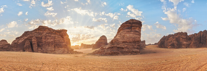 Morning sun shines over rocky desert formations, typical landscape in Al Ula, Saudi Arabia. High resolution panorama