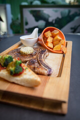 a glass of whiskey and a fresh steak with sauce