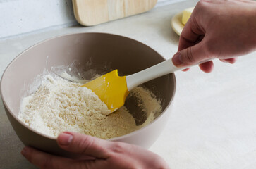 The process of kneading the dough for making pampushky, a traditional Ukrainian bun for borsch. The concept of traditional dishes. Homemade baking. Horizontal orientation.