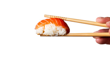 Salmon nigiri grabbed by wooden chopsticks on trasparent background