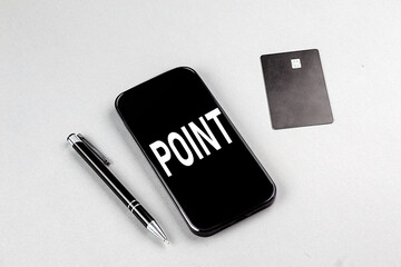 POINT word on smartphone with credit card and pen
