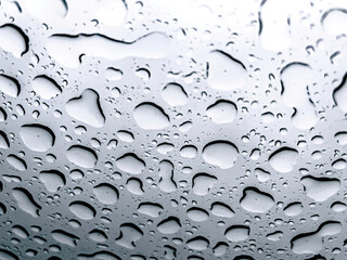Raindrops on the window close-up, abstract natural background.