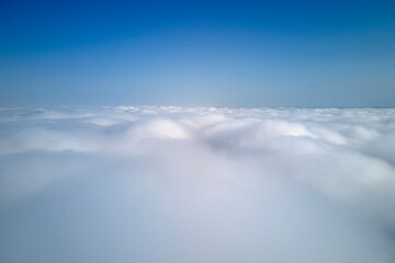 Aerial view from high altitude of earth covered with puffy rainy clouds forming before rainstorm