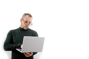 Horizontal banner of a beautiful smiling business man holding laptop in his hands, typing and browsing the web, isolated on a gray background with a copy space