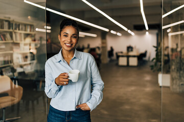 Happy African businesswoman taking a break after hard work at the office.