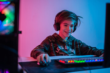 computer games, playing place, young gamer plays computer games with headphones,